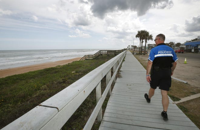 Flagler Beach chief of police Matthew Doughney surveys the closing of Flagler Beach and boardwalk area, Monday, March 23, 2020. [News-Journal/Nigel Cook]