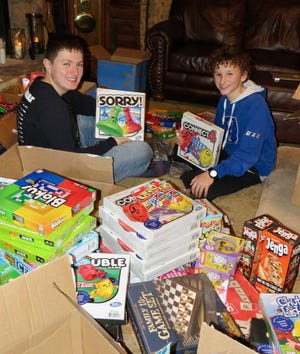 Lincoln High School ninth-graders Hayden Slade, left, and Grady Smith gather games to donate through their nonprofit Games to Give program. [Submitted]