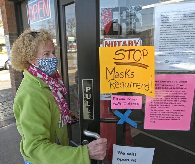 Bridget Niemic, of Millcreek Township, Erie County, enters the Pony Express shipping, postage and delivery store in Erie on Monday. The store has implemented a mandatory face mask policy for patrons. [Christopher Millette/Erie (Pa.) Times-News via AP]