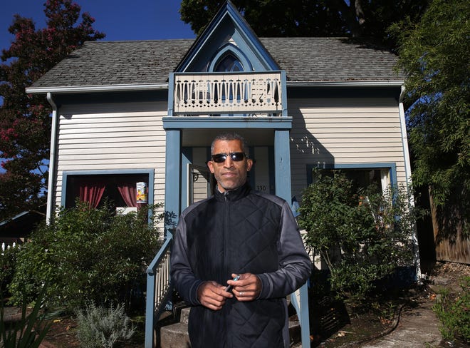 NAACP President Eric Richardson stands in front of the historical Mims House, a location for student meal pickup. [Chris Pietsch/The Register-Guard file] - registerguard.com
