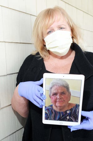 Gloria Goodwin, of Hull, holds a photograph of her aunt Jeannette Maranhao, on Monday, April 6, 2020, who died of the coronavirus at Southeast Rehabilitation Skilled Care Center in Easton. (Marc Vasconcellos/The Enterprise)
