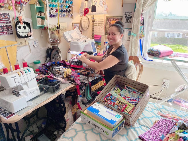 Brenda Thorp is pictured in her home sewing face masks. Thorp has sewn over 2,000 masks since starting the project in mid-March. PROVIDED PHOTO