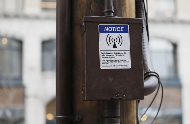 A sticker warns about radio frequencies exceeding FCC limits on a newly installed 5G cell tower.. [Adam Cairns/Dispatch]