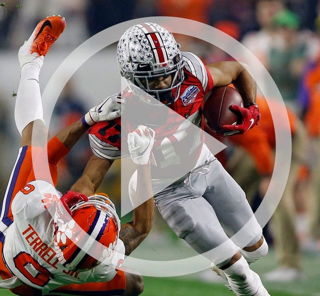 In this file photo Ohio State Buckeyes wide receiver Chris Olave (17) makes a catch and throws down Clemson Tigers cornerback Brian Dawkins Jr. (9) in the 1st quarter of their game in College Football Playoff Semifinal at the PlayStation Festa Bowl at State Farm Stadium in Glendale, Ariz. December 28, 2019.