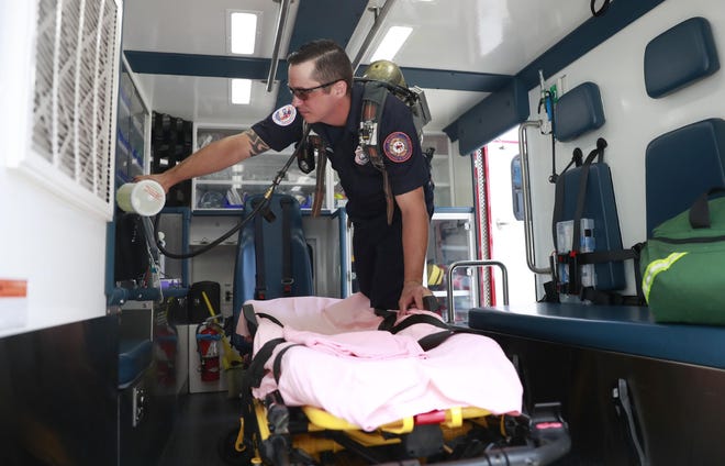 Firefighter EMT Brandon Luczaj uses a locally made device to decontaminate an ambulance on Tuesday at the Thomas Drive Volunteer Fire Department Station 1. The fire department has worked with the Florida Department of Health of Bay County to make a device that can be used to quickly decontaminate EMS vehicles and equipment. [PATTI BLAKE/THE NEWS HERALD]