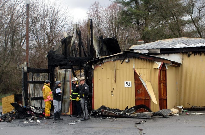 Fire inspectors and State Police go through what was left of the Lighthouse Community Church in Earlville April 9 after a devastating blaze the night before. No injuries were reported but the building itself appeared to be a total loss. [MIKE JAQUAYS/MID-YORK WEEKLY]