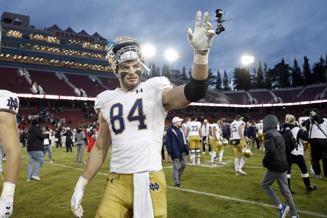 Notre Dame tight end Cole Kmet waves while leaving the field after a game against Stanford on Nov. 13. Kmet looks like he’d be a good fit with the Patriots on Draft day. [USA TODAY SPORTS, file / Darren Yamashita]
