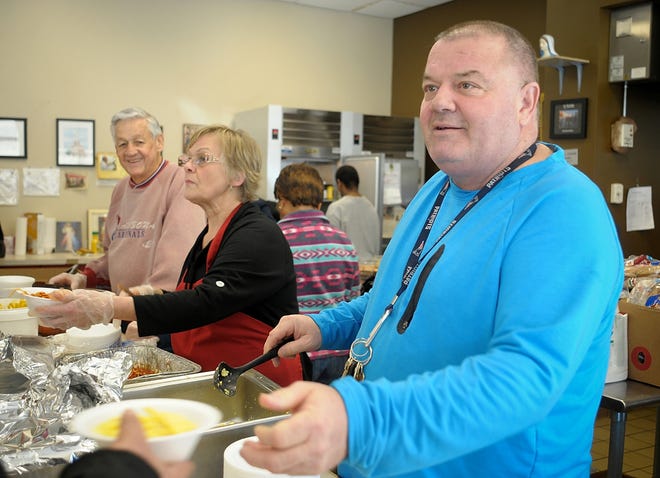 Billy Riley dishes out food with a smile at the St. Francis Xavier Center in Worcester on March 6, 2018. [T&G Staff File Photo/Rick Cinclair]