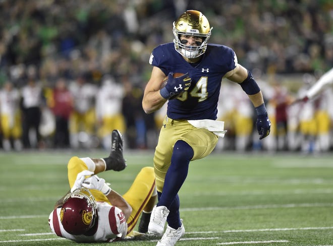 Notre Dame tight end Cole Kmet leaves a defender behind while scoring a touchdown against Southern Cal last season. [File Photo/Quinn Harris/USA TODAY Sports]