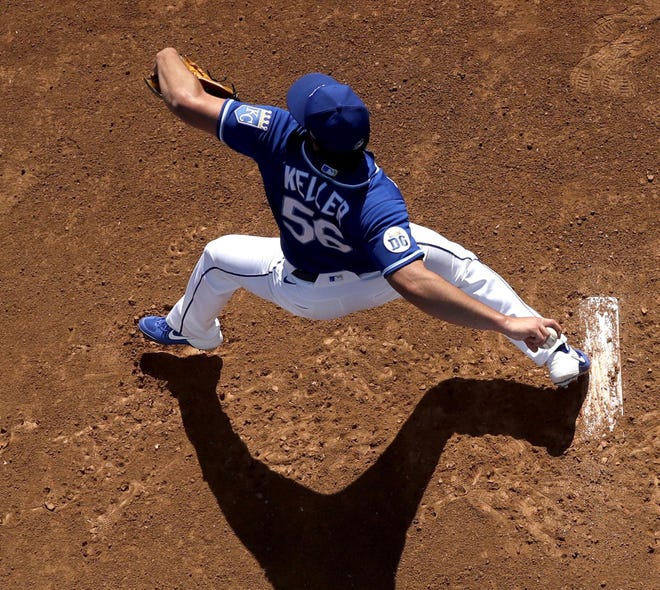 Kansas City Royals pitcher Brad Keller throws in the bullpen before a spring training baseball game against the San Diego Padres on Feb. 24 in Surprise, Ariz. Under a possible plan, the Royals would play their season in Arizona as part of a league-wide realignment for the 2020 season. [Charlie Riedel/The Associated Press]
