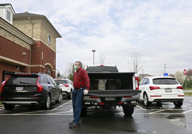 Customer Ray Klosz of Powell waits for his order in the grocery pickup area at the Kroger Marketplace on Sawmill Road in Dublin. [Barbara J. Perenic/Dispatch]
