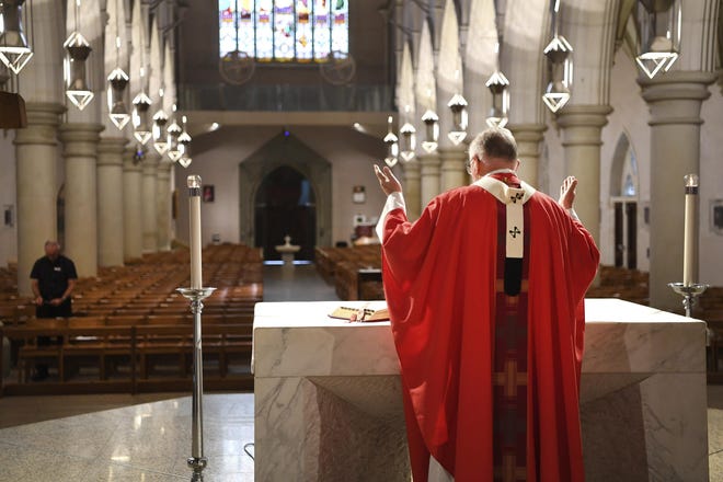 Archbishop Mark Coleridge delivers a Good Friday mass to an empty St. Stephen's Cathedral in Brisbane, Australia, Friday, April 10, 2020. People around the world have begun celebrating Good Friday and Easter from the safety of their homes in an effort to help arrest the coronavirus outbreak. (Dan Peled/AAP Image via AP)