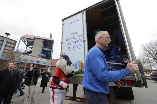 Boston Red Sox spring training baseball equipment truck driver Alan Hartz of Milford (right) opens a door to the truck during a ceremonial stop at McCoy Stadium, in Pawtucket, R.I., Monday, Feb. 3. (AP File Photo/Steven Senne)
