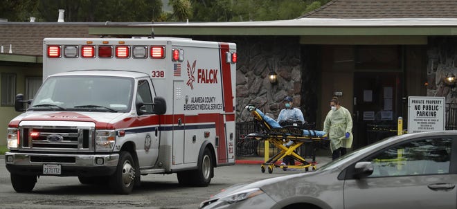 Emergency medical technicians move a stretcher at the Gateway Care and Rehabilitation Center in Hayward. Skilled nursing facilities are especially vulnerable to the coronavirus and more than 1,200 residents and staff have tested positive in California. [BEN MARGOT/AP]
