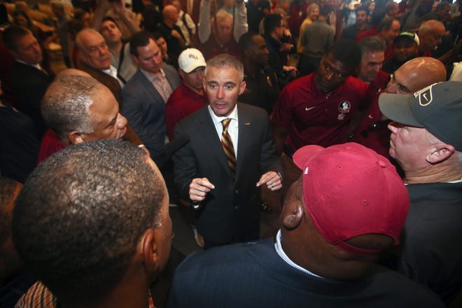Florida State head football coach Mike Norvell talks to football staffers after a press conference Sunday, Dec. 8, 2019, in Tallahassee, Fla. Norvell is Florida State's new coach, taking over a Seminoles program that has struggled while he was helping to build Memphis into a Group of Five power. (AP Photo/Phil Sears)