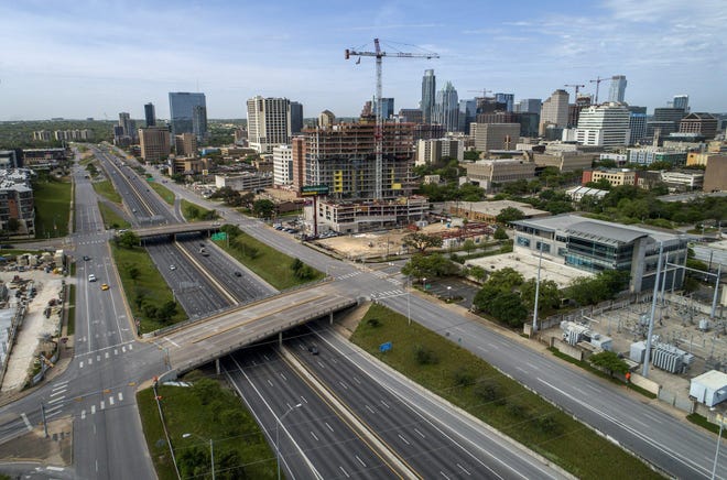 Light traffic flows on Interstate 35 in downtown Austin last month during a continuing stay-at-home order due to the coronavirus. [JAY JANNER/AMERICAN-STATESMAN]
