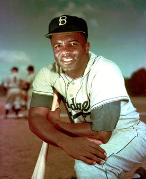 In this 1952 file photo, Brooklyn Dodgers baseball player Jackie Robinson poses. Forced from the field by the new coronavirus, Major League Baseball is moving its annual celebration of Jackie Robinson online. The Jackie Robinson Foundation launched a virtual learning hub to coincide with the 73rd anniversary Wednesday, April 15, 2020, of Robinson breaking the major league color barrier. [Associated Press]
