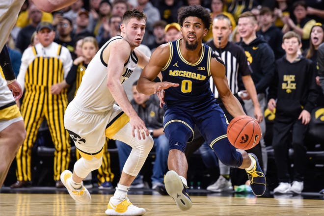 Michigan guard David DeJulius (0) drives toward the basket against Iowa during a game Jan. 17 at Carver-Hawkeye Arena in Iowa City, Iowa. DeJulius announced Thursday he is transferring to Cincinnati. Missouri was among his final four suitors. [Jeffrey Becker/USA TODAY Sports]