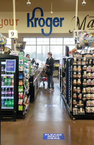 Kroger announced the adoption of customer capacity limits to further encourage physical distancing in stores. and began to limit the number of customers to 50% of the international building code's calculated capacity on Tuesday, April 7, 2020. Signs of the influence of the cornoavirus were evident at the Kroger Marketplace on Sawmill Road in Dublin. [Barbara J. Perenic/Dispatch]