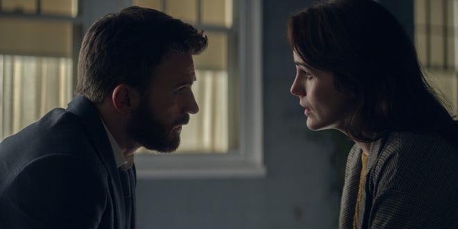 Michelle Dockery and Chris Evans have an intense discussion about their son’s guilt or innocence. [Apple TV+]