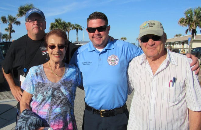 Welcoming folks to Flagler Beach on Friday evening at Veterans Park are, from left, City Manager Larry Newsom, City Commissioner Jane Mealy, Fire Chief Bobby Pace and former commissioner Marshall Shupe.