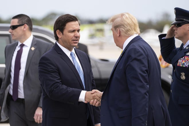 Gov. Ron DeSantis, R-Fla., greets President Donald Trump as he steps off Air Force One upon arrival at the Orlando Sanford International Airport, Monday, March 9, 2020 in Orlando, Fla. (AP Photo/Alex Brandon)
