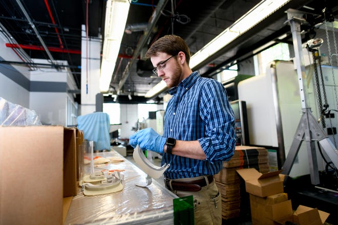 Matt White, who grew up in Gastonia, assembles a face shield at N.C. State’s Center for Additive Manufacturing and Logistics in Raleigh. [North Carolina State University/Special to the Gazette]