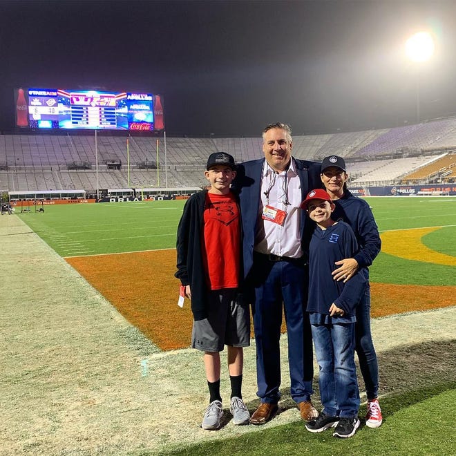 Larry Antonucci stands with, left to right, sons Johnny and Joey and wife Danielle on the field at the University of Central Florida following opening night of the now-defunct Alliance of American Football. [Courtesy photo / Larry Antonucci]