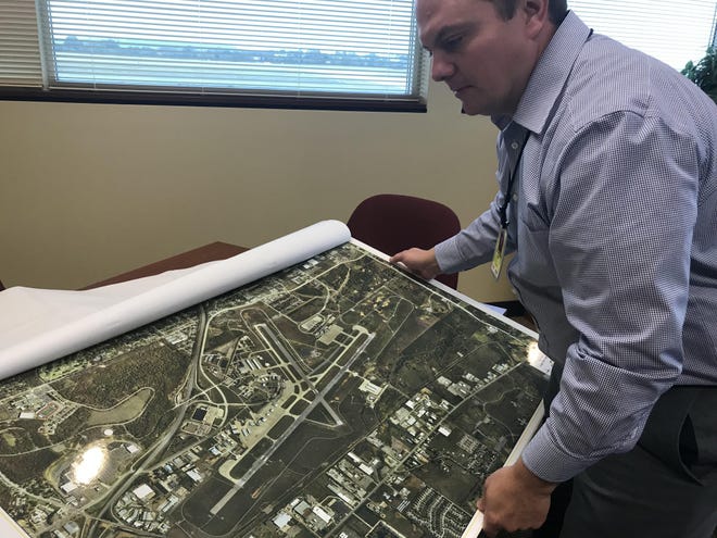 Fort Smith Regional Airport Director Michael Griffin shows an aerial map of airport property in 2017. The airport recently has been awarded over $11.6 million in aid by the Federal Aviation Administration as response to the impacts of the coronavirus pandemic restricting flights. [Times Record File Photo]