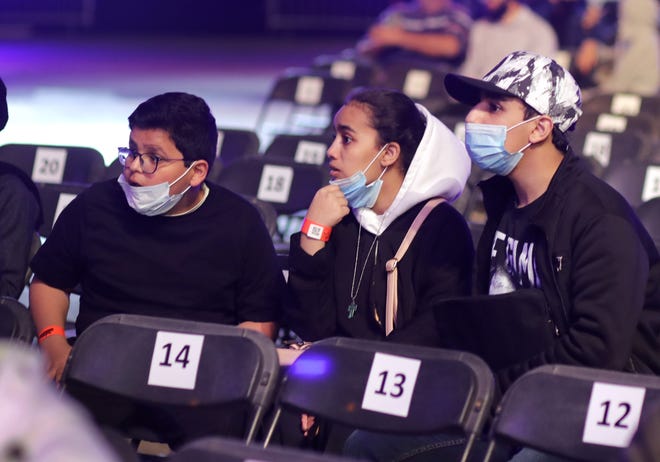 Saudi wrestling fans wear protective masks as they wait for wrestling matches of WWE Super ShowDown in Riyadh, Saudi Arabia, on Feb. 27, 2020. Pro wrestling matches throughout the world have now been canceled or postponed due to the coronavirus pandemic. [AP File Photo/Amr Nabil]