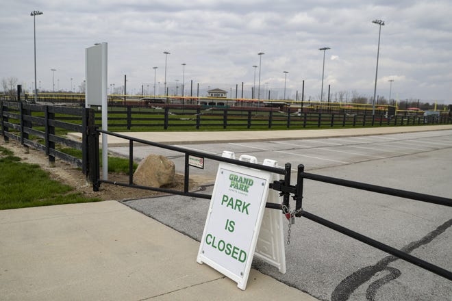 The gates to the Grand Park Sports Campus fields are locked in Westfield, Ind., this month because of the coronavirus. Officials estimate that central Indiana could lose more than $85 million in direct spending if Grand Park stays closed through June. [Michael Conroy/The Associated Press]