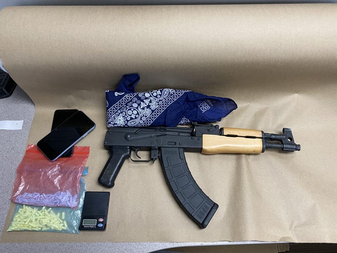A photo provided by the San Bernardino County Sheriff’s Department shows what authorities called a ’short barrel AK47’ and Xanax pills, along with a digital scale and two cell phones. [PHOTO COURTESY OF SAN BERNARDINO COUNTY SHERIFF’S DEPARTMENT]