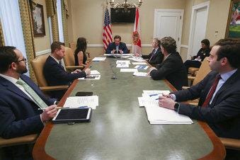 Gov. Ron DeSantis holds a conference call with the Re-Open Florida Task Force at the Capitol Monday, April 20, 2020. (Tori Lynn Schneider/Tallahassee Democrat via AP)