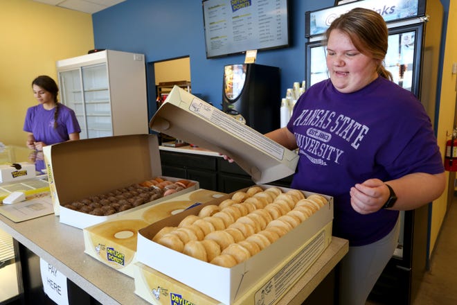 Ashlyn Neufeld, 15, right, talks about the doughnuts that will be donated to Hutchinson Regional Medical Center Monday at noon at Daylight Donuts, 1435 East 30th Ave., with Gracie Younger, left. The store closes at noon and the extra donuts are donated to people in the area. [Sandra J. Milburn/HutchNews]