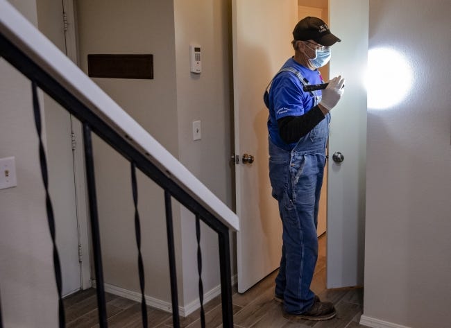 Phillip Culp, of K9 Termite Finders, inspects the closet of a home at 9905 Hefner Village Place. [CHRIS LANDSBERGER/THE OKLAHOMAN]