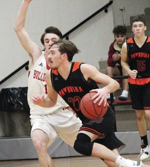 Pawhuska High’s Easton Kirk drives against a Dewey High defender during boys basketball action in the 2018-19 campaign. Mike Tupa/Examiner-Enterprise
