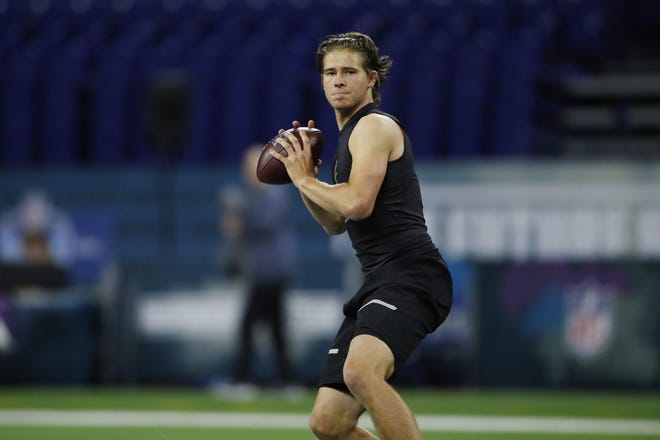 Oregon Ducks quarterback Justin Herbert gets set to throw a pass during the 2020 NFL Combine Feb. 27 at Lucas Oil Stadium in Indianapolis. The Patriots would have to trade up to nearly the top of the first round of the NFL Draft Thursday to have a chance at the 6-foot-6-inch athlete. [USA Today Sports, file / Brian Spurlock]