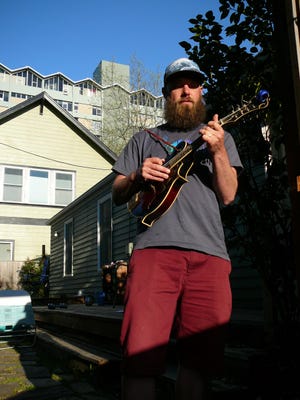 Jesse Lawton, who plays the mandolin, is a professional musician and singer in the band Alder Street. [Kurt Catlin/For The Register-Guard]