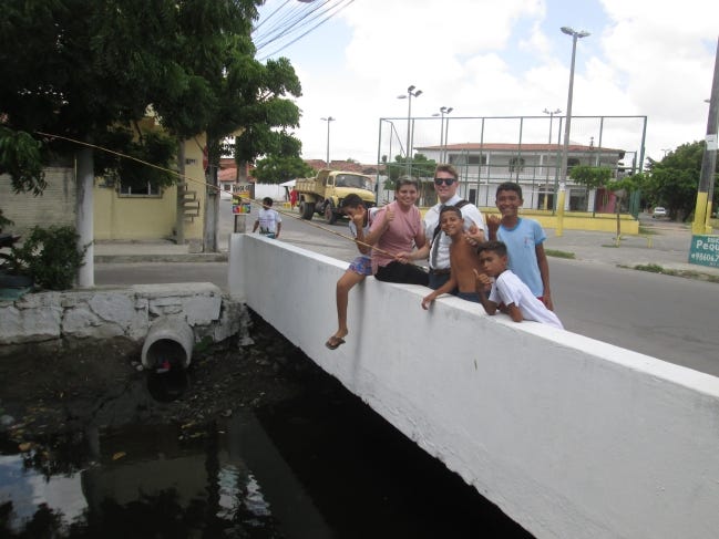 Jackson Balkman, of Norman, is shown fishing with a group of boys in Brazil while on assignment as a Church of Jesus Christ of Latter-day Saints missionary. [Provided/Jackson Balkman]