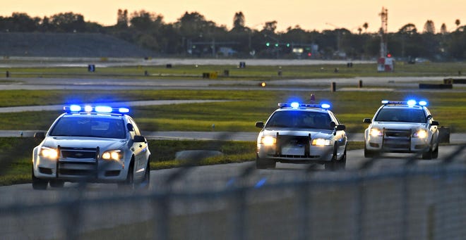 Manatee County sheriff’s deputies enter the Sarasota-Bradenton International Airport on Tuesday evening. There, they arrested a Bradenton man who reportedly ran a red light on his dirt bike and then scaled the airport fence. [HERALD-TRIBUNE STAFF PHOTO / THOMAS BENDER]
