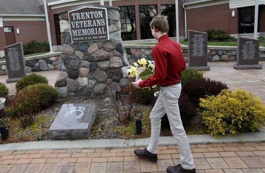 Ian Kramp, 14 of Allen Park and an 8th grader at Boyd W. Arthurs Middle School in Trenton walks up to lay a wreath at the Trenton Veterans Memorial on Wednesday, April 22, 2020. Kramp, couldn't do his school's field trip to Washington DC where he was to lay a wreath at the Arlington National Cemetery because of the Coronavirus COVID-19. He wanted to find a way to honor veterans anyway and chose to do it this way. (Photo: Eric Seals, Detroit Free Press)