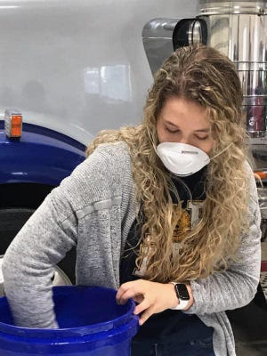 Mixing and drawing the winners in the coronavirus-delayed Kewanee and Wethersfield FFA Grocery Giveaway drawing is Wethersfield FFA president Hattie Rose, appropriately protected by a face mask.[Photo from Kewanee FFA Facebook]