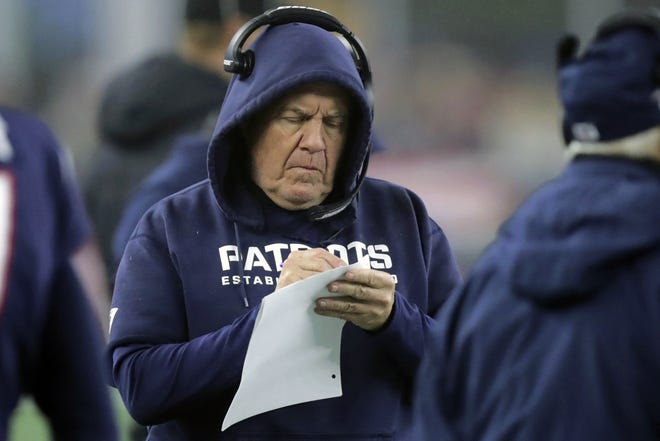 In this Jan. 4, 2020, file photo, New England Patriots head coach Bill Belichick takes notes on the sideline in the first half of an NFL wild-card playoff football game against the Tennessee Titans in Foxborough. (AP File Photo/Charles Krupa)