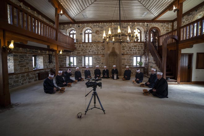 Imams attend the Ramadan prayer at a mosque empty of faithful due to social distancing guidelines during the coronavirus outbreak in Zenica, central Bosnia, Thursday, April 23, 2020. The COVID-19 virus pandemic is cutting off the world's Muslims from their cherished Ramadan traditions. (AP Photo/Almir Alic)