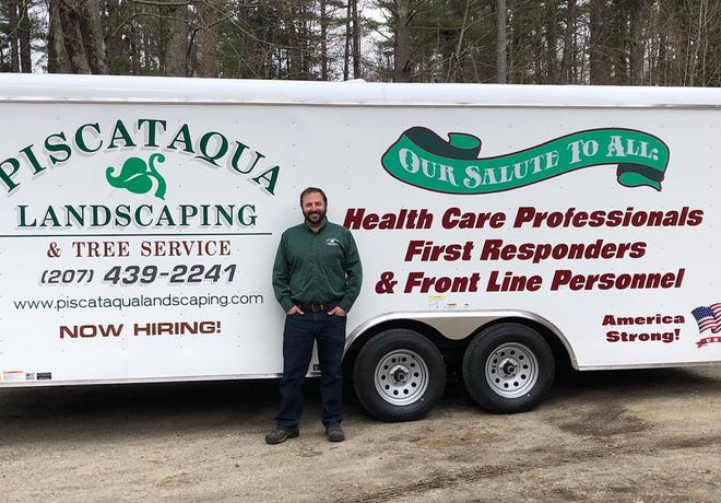 Justin Gamester, president and CEO of Piscataqua Landscaping & Tree Service, unveils a special message to area health care and essential workers on a new enclosed lawn maintenance trailer. [Courtesy]
