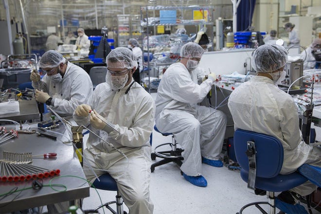 Employees work in a clean room at Dynamic Manufacturing Solutions in Austin in 2017. A new report from the Federal Reserve Bank of Dallas indicates manufacturing activity has declined dramatically in the state amid the coronavirus crisis. [AMERICAN-STATESMAN FILE]