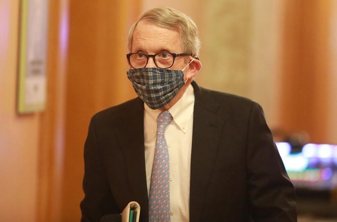 Wearing his protective mask made by his wife, Ohio Gov. Mike DeWine walks into his daily coronavirus news conference on Thursday, April 16, 2020 at the Ohio Statehouse in Columbus, Ohio.  (Doral Chenoweth/Columbus Dispatch)