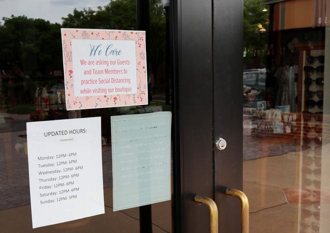 Some Edmond businesses are preparing to open on Friday. Francesca’s in Spring Creek Village posted these signs on their doors Tuesday. [Doug Hoke/The Oklahoman]