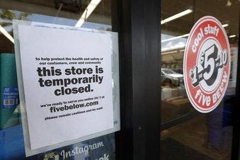 A sign is posted on a closed North Miami storefront. [AP Photo/Wilfredo Lee]