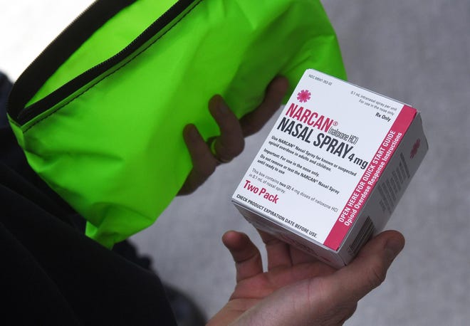 Portsmouth Fire Chief Todd Germain holds an opioid overdose kit, which firefighters will leave where people have overdosed, along with information about how and where to get help. [Deb Cram/Seacoastonline]